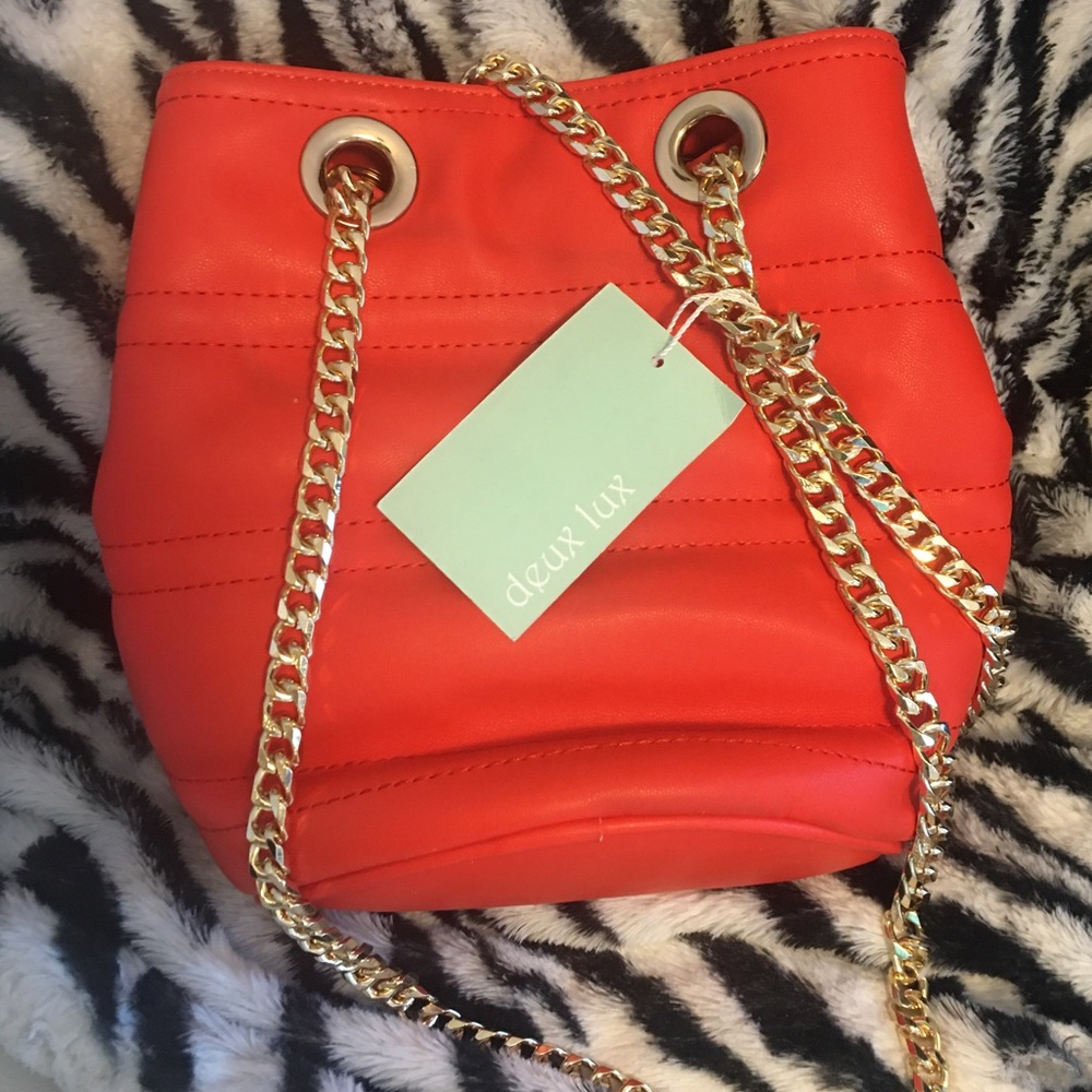 Orange hobo bag with gold chain strap
